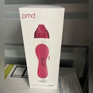 PMD Skincare Device in Pink and White